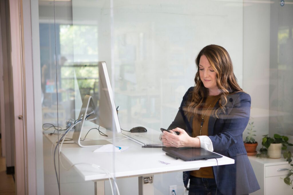 A woman at her desk communicating with her virtual assistant