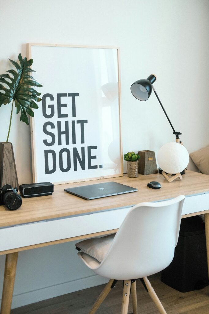 A desk with a sign that says "Get Shit Done"